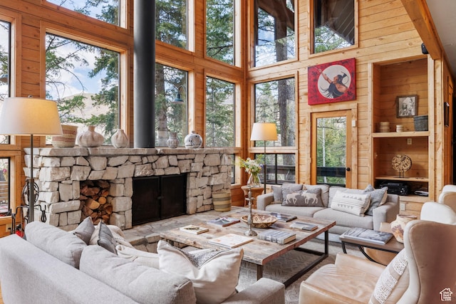 3057 E Balsam Rd, Sundance, UT 84604 - living area with wood walls, healthy amount of natural light, a towering ceiling, and a stone fireplace