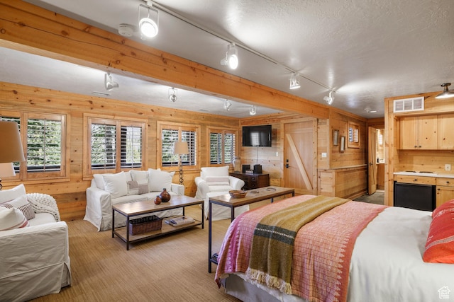 3057 E Balsam Rd, Sundance, UT 84604 - bedroom featuring wood walls, rail lighting, fridge, and a textured ceiling