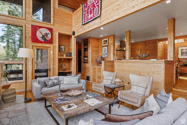 3057 E Balsam Rd, Sundance, UT 84604 - living area with wood walls, healthy amount of natural light, a high ceiling, wood finished floors, and recessed lighting