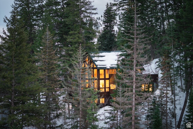 3057 E Balsam Rd, Sundance, UT 84604 - view of snowy exterior with a wooded view and a sunroom