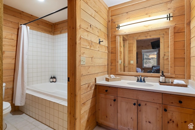 3057 E Balsam Rd, Sundance, UT 84604 - bathroom with wooden walls, toilet, vanity, tile patterned floors, and tiled shower / bath combo