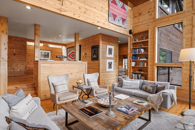 3057 E Balsam Rd, Sundance, UT 84604 - living room with wooden walls, a towering ceiling, hardwood / wood-style flooring, recessed lighting, and a fireplace