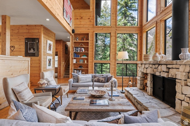 3057 E Balsam Rd, Sundance, UT 84604 - living room with wood finished floors, wooden walls, recessed lighting, a towering ceiling, and a fireplace