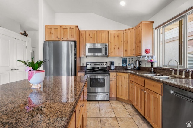 2193 E Robie Hill Ln, Millcreek, UT 84109 - kitchen with appliances with stainless steel finishes, a sink, vaulted ceiling, light marble finish floors, and dark stone counters