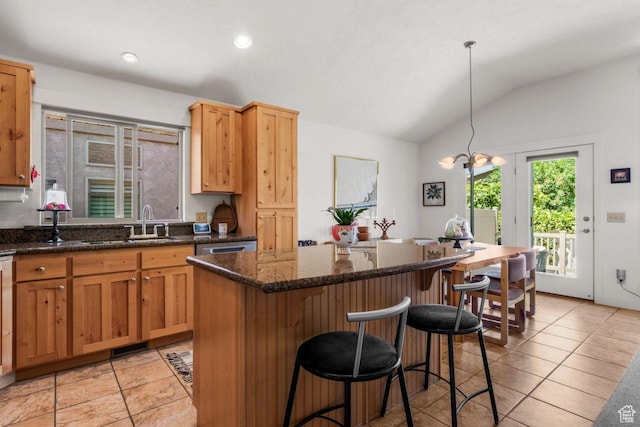 2193 E Robie Hill Ln, Millcreek, UT 84109 - kitchen with vaulted ceiling, a kitchen island, a kitchen bar, light tile patterned floors, and dark stone countertops