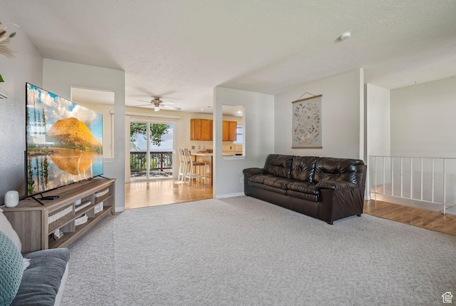 8962 S Altair Dr, Sandy, UT 84093 - carpeted living room featuring ceiling fan, baseboards, and wood finished floors