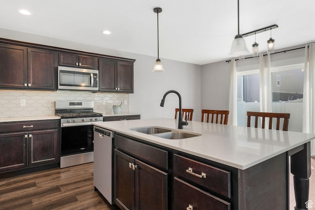 12364 S Boggs Way, Herriman, UT 84096 - kitchen featuring stainless steel appliances, a sink, tasteful backsplash, dark wood-style floors, and pendant lighting