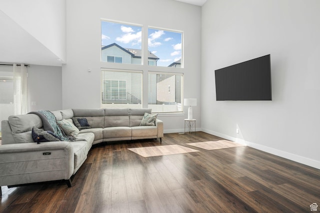 12364 S Boggs Way, Herriman, UT 84096 - living room featuring dark wood-type flooring, a towering ceiling, and baseboards