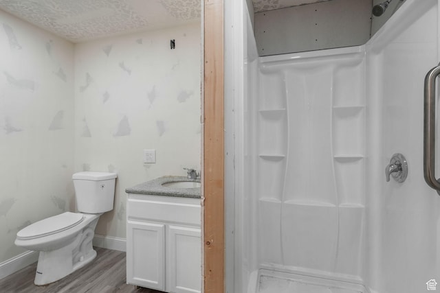12364 S Boggs Way, Herriman, UT 84096 - bathroom featuring a shower, wood finished floors, toilet, vanity, and baseboards