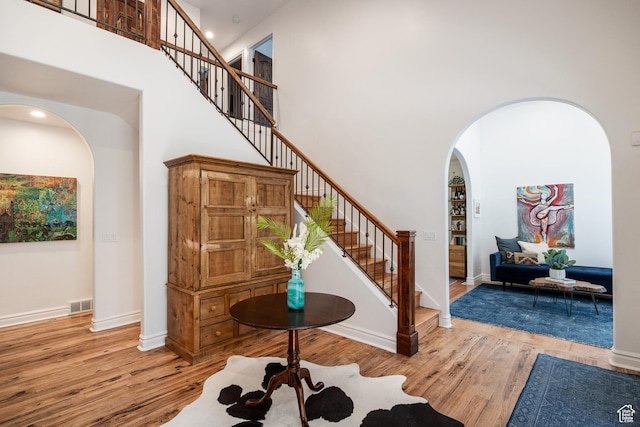 1877 E 3990 S, Holladay, UT 84124 - entrance foyer with a high ceiling, wood finished floors, arched walkways, stairs, and baseboards