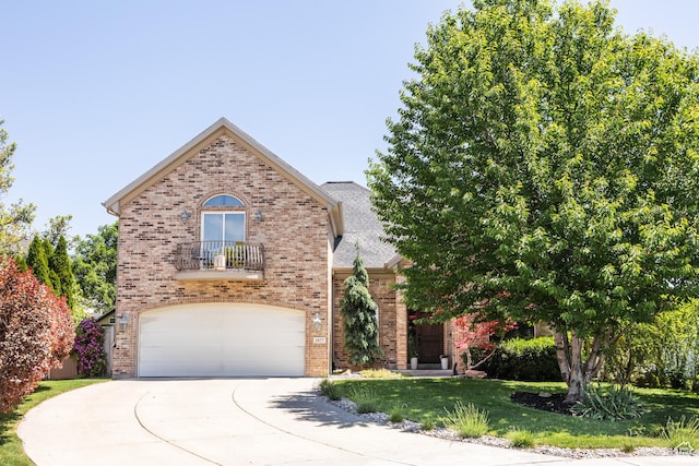 1877 E 3990 S, Holladay, UT 84124 - view of front facade featuring brick siding, driveway, a garage, a front yard, and a balcony