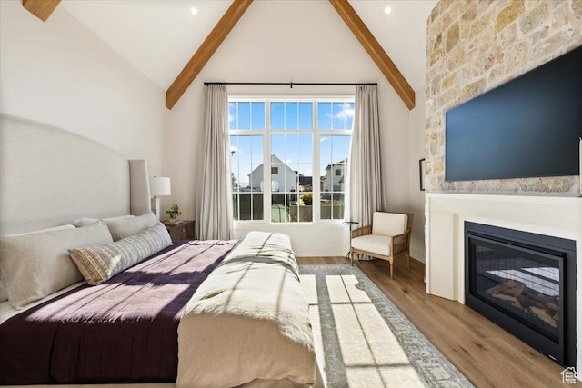 478 S Maple Lakes Dr, Mapleton, UT 84664 - bedroom featuring beamed ceiling, a glass covered fireplace, wood finished floors, and high vaulted ceiling