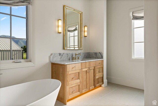 478 S Maple Lakes Dr, Mapleton, UT 84664 - full bathroom with a soaking tub, vanity, tile patterned flooring, and baseboards