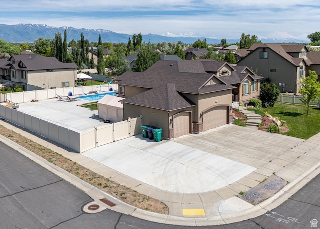 4962 S 5050 W, Hooper, UT 84315 - view of front of house featuring a gate, a shingled roof, a residential view, stucco siding, and driveway