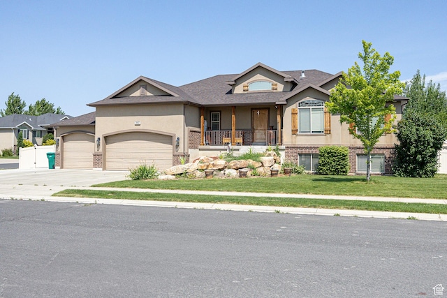4962 S 5050 W, Hooper, UT 84315 - view of front facade with stucco siding, an attached garage, a front lawn, concrete driveway, and covered porch