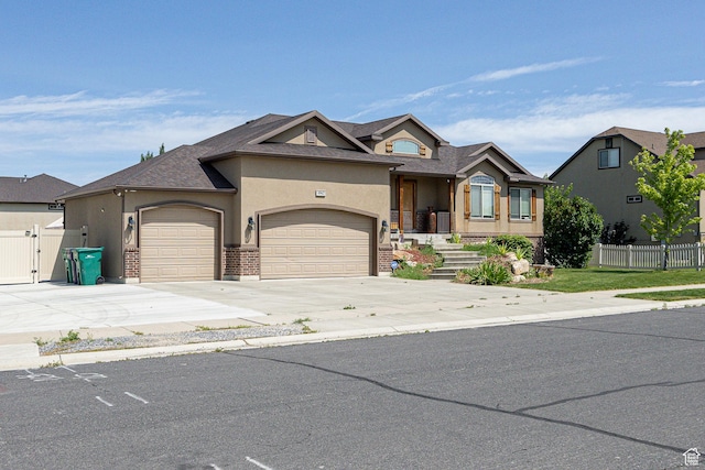 4962 S 5050 W, Hooper, UT 84315 - view of front of home featuring a garage, stucco siding, driveway, roof with shingles, and a gate