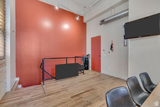 342 W 200 S Unit 107, Salt Lake City, UT 84101 - misc room with a towering ceiling, wood finished floors, and track lighting
