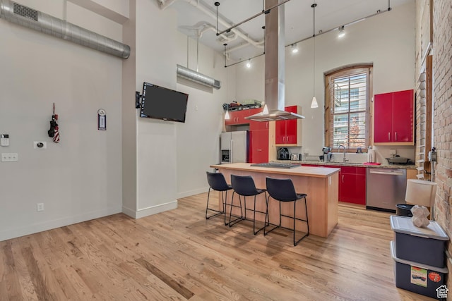 342 W 200 S Unit 107, Salt Lake City, UT 84101 - kitchen with stainless steel appliances, track lighting, a kitchen island, island exhaust hood, and light wood-type flooring