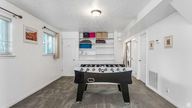 7505 S Creek Rd E, Cottonwood Heights, UT 84093 - recreation room featuring a textured ceiling, dark carpet, and baseboards