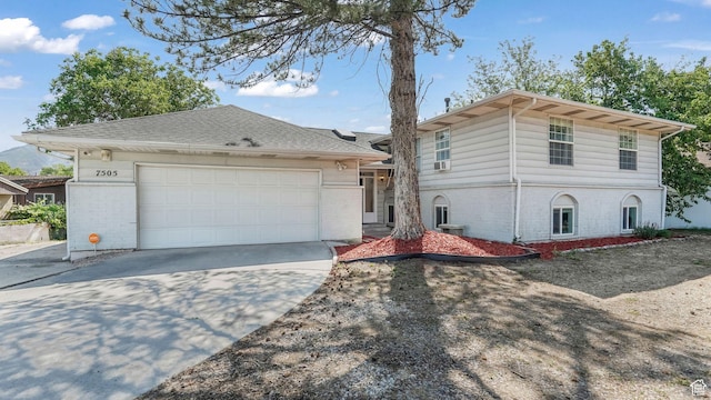 7505 S Creek Rd E, Cottonwood Heights, UT 84093 - view of front of home featuring brick siding, driveway, and a garage
