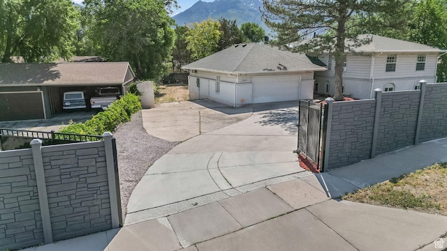 7505 S Creek Rd E, Cottonwood Heights, UT 84093 - ranch-style home with a gate, a mountain view, and a garage