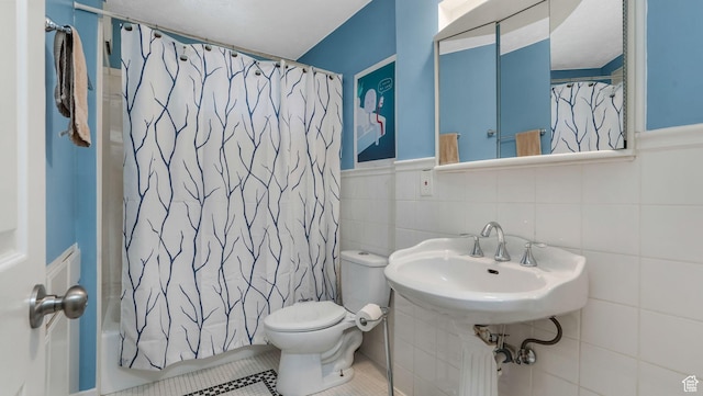 7505 S Creek Rd E, Cottonwood Heights, UT 84093 - full bathroom featuring toilet, a sink, tile walls, tile patterned floors, and shower / tub combo with curtain