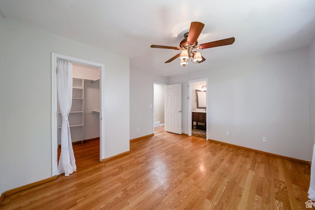4213 S 2850 W, Roy, UT 84067 - unfurnished bedroom with a spacious closet, baseboards, light wood-style floors, a closet, and a ceiling fan