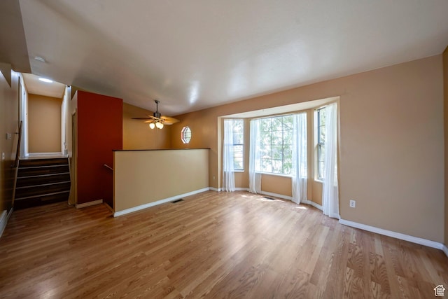4213 S 2850 W, Roy, UT 84067 - unfurnished living room featuring wood finished floors, ceiling fan, baseboards, and stairs