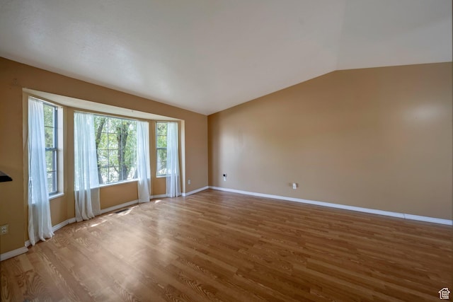 4213 S 2850 W, Roy, UT 84067 - spare room featuring vaulted ceiling, wood finished floors, and baseboards