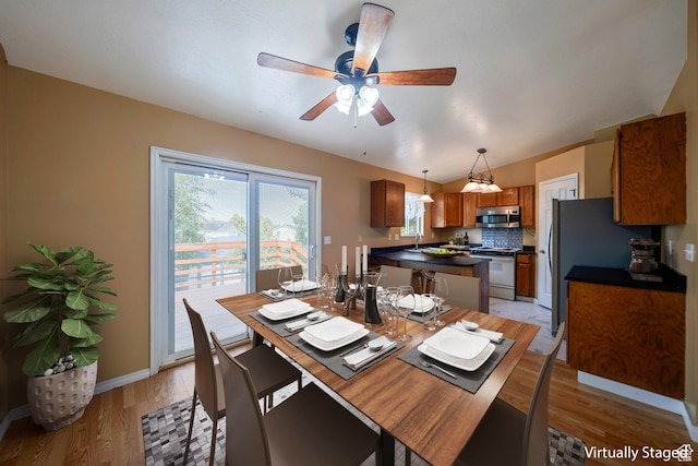 4213 S 2850 W, Roy, UT 84067 - dining space with light wood finished floors, ceiling fan, lofted ceiling, and baseboards
