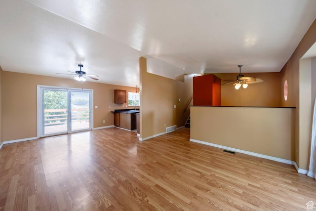 4213 S 2850 W, Roy, UT 84067 - unfurnished living room with a ceiling fan, light wood-type flooring, baseboards, and stairs