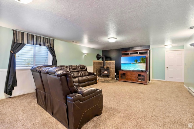 1092 S 470 E, Providence, UT 84332 - living area featuring a textured ceiling, carpet floors, a wood stove, and baseboards
