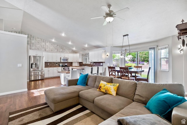 1092 S 470 E, Providence, UT 84332 - living area with vaulted ceiling, wood finished floors, a ceiling fan, and baseboards