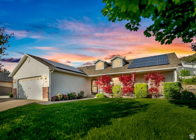 1092 S 470 E, Providence, UT 84332 - view of front of house featuring roof mounted solar panels, a front lawn, an attached garage, and driveway