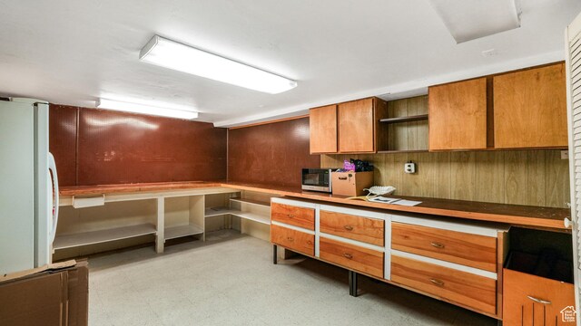 412 S 100 E, Salem, UT 84653 - kitchen featuring freestanding refrigerator, open shelves, brown cabinets, light flooring, and wooden walls