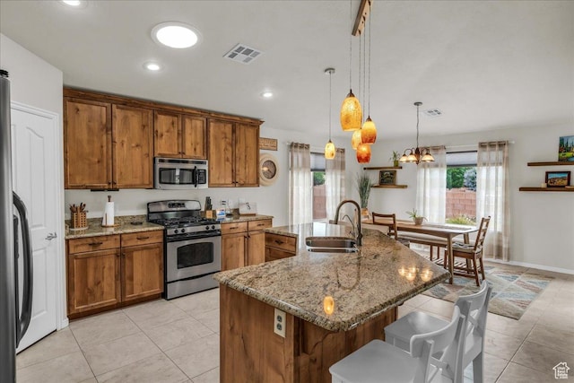 4034 Fortune Way, Washington, UT 84780 - kitchen featuring stainless steel appliances, a sink, brown cabinets, a breakfast bar area, and light tile patterned flooring