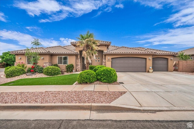 4034 Fortune Way, Washington, UT 84780 - mediterranean / spanish-style home with stucco siding, an attached garage, concrete driveway, and a tiled roof