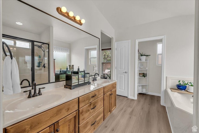4034 Fortune Way, Washington, UT 84780 - bathroom featuring wood finished floors, double vanity, a bath, and a stall shower