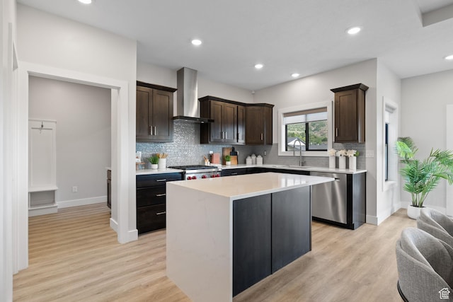 915 E 2100 N, North Ogden, UT 84414 - kitchen with stainless steel dishwasher, wall chimney exhaust hood, a sink, dark brown cabinetry, and a kitchen island