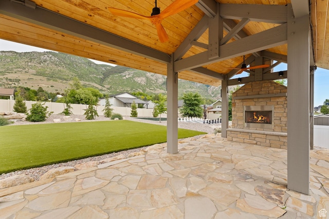 915 E 2100 N, North Ogden, UT 84414 - view of patio featuring an outdoor stone fireplace, ceiling fan, a mountain view, and a gazebo