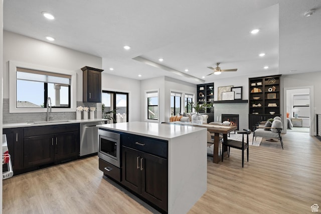 915 E 2100 N, North Ogden, UT 84414 - kitchen with a sink, stainless steel appliances, light countertops, light wood-type flooring, and recessed lighting