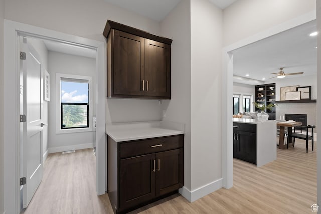 915 E 2100 N, North Ogden, UT 84414 - bar area featuring light wood-type flooring, baseboards, plenty of natural light, a ceiling fan, and recessed lighting