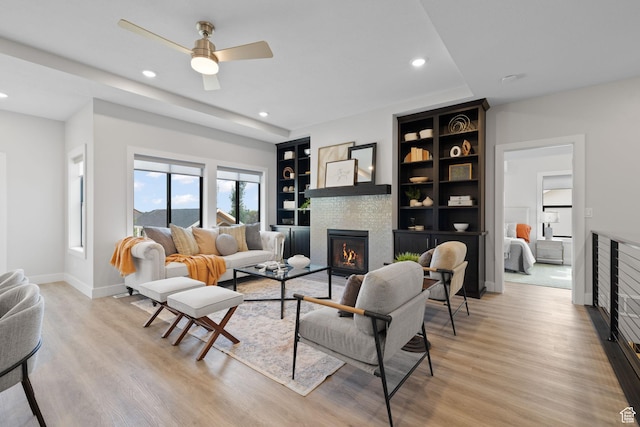 915 E 2100 N, North Ogden, UT 84414 - living area featuring a glass covered fireplace, recessed lighting, light wood-type flooring, ceiling fan, and baseboards