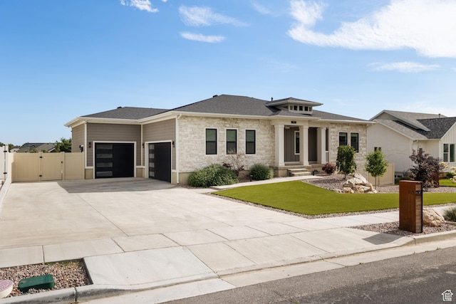 915 E 2100 N, North Ogden, UT 84414 - prairie-style house featuring a garage, a gate, driveway, stone siding, and roof with shingles