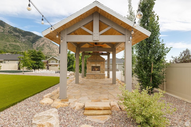 915 E 2100 N, North Ogden, UT 84414 - view of patio featuring an outdoor stone fireplace, a gazebo, and a mountain view