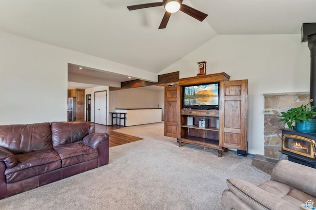 6530 Snow View Dr, Park City, UT 84098 - living area featuring a wood stove, a ceiling fan, carpet floors, and vaulted ceiling