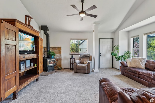 6530 Snow View Dr, Park City, UT 84098 - living room featuring a wood stove, carpet, vaulted ceiling, and ceiling fan