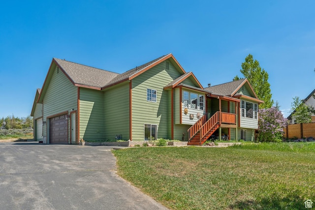 6530 Snow View Dr, Park City, UT 84098 - view of front of home with driveway, an attached garage, stairway, a front lawn, and a shingled roof