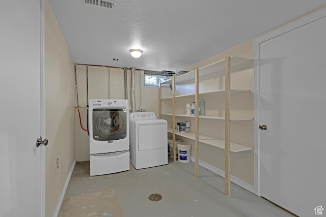 2458 N 575 E, North Ogden, UT 84414 - laundry area featuring washer and dryer, baseboards, and a textured ceiling