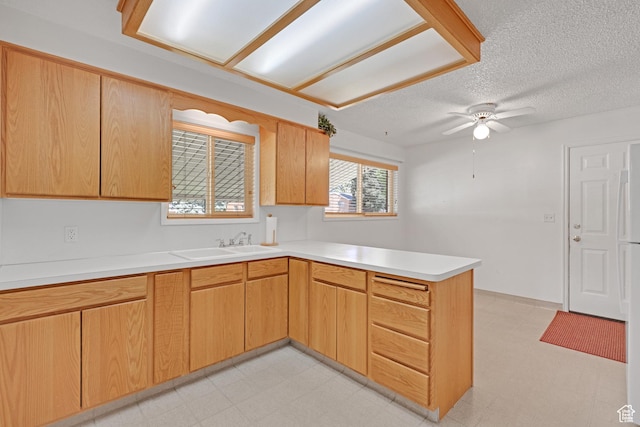 2458 N 575 E, North Ogden, UT 84414 - kitchen featuring a peninsula, a sink, light floors, light countertops, and a textured ceiling